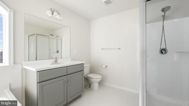 bathroom featuring a wealth of natural light, vanity, toilet, and a shower with door