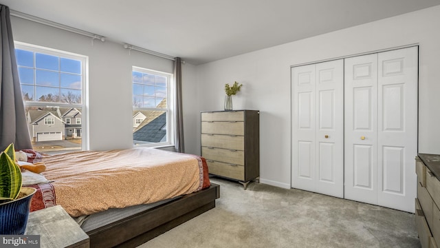 bedroom with a closet and light colored carpet