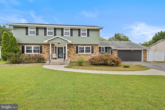 view of front of house with a garage and a front yard