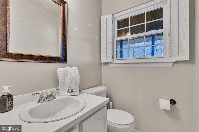 half bathroom featuring toilet and vanity