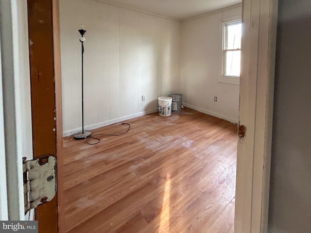 empty room featuring baseboards and wood finished floors