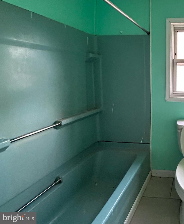 full bathroom with tile patterned flooring, baseboards, toilet, and shower / bathtub combination