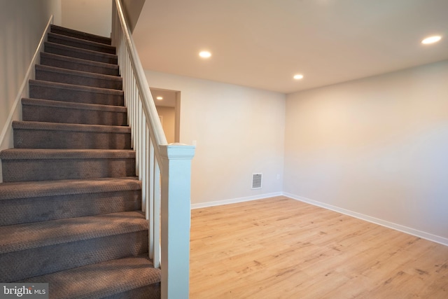 stairway featuring wood-type flooring