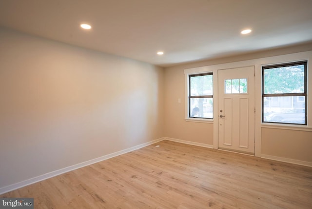 foyer with a wealth of natural light and light hardwood / wood-style floors