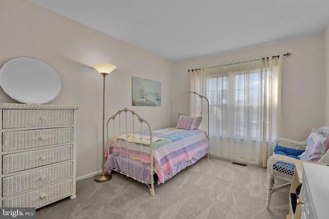 bedroom featuring light colored carpet