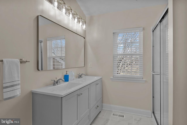 bathroom featuring vanity and an enclosed shower