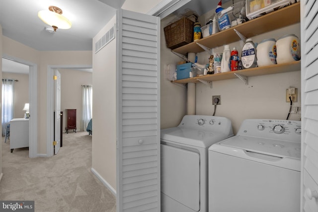 laundry room with light carpet and washing machine and clothes dryer