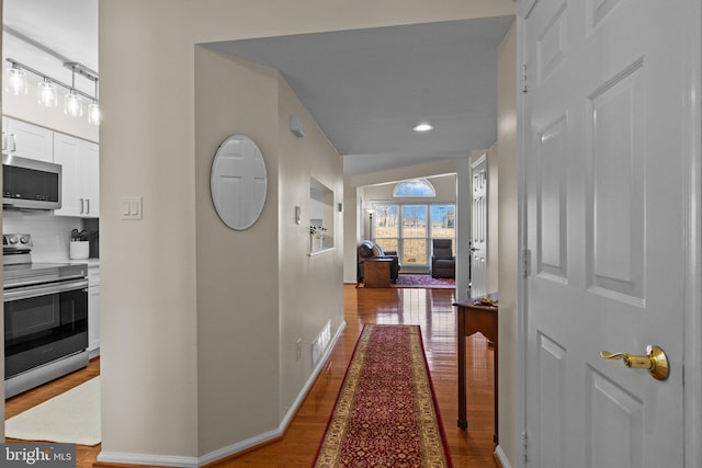 corridor with hardwood / wood-style floors