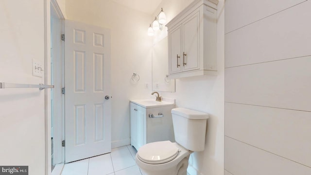 half bath featuring vanity, toilet, and tile patterned floors