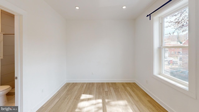 spare room with recessed lighting, baseboards, and light wood finished floors