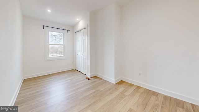 spare room featuring visible vents, baseboards, wood finished floors, and recessed lighting