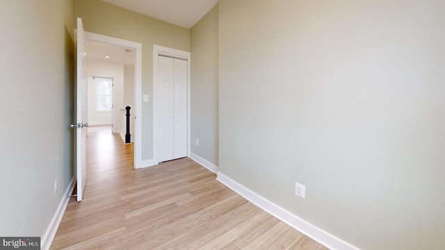 interior space featuring light wood finished floors and baseboards