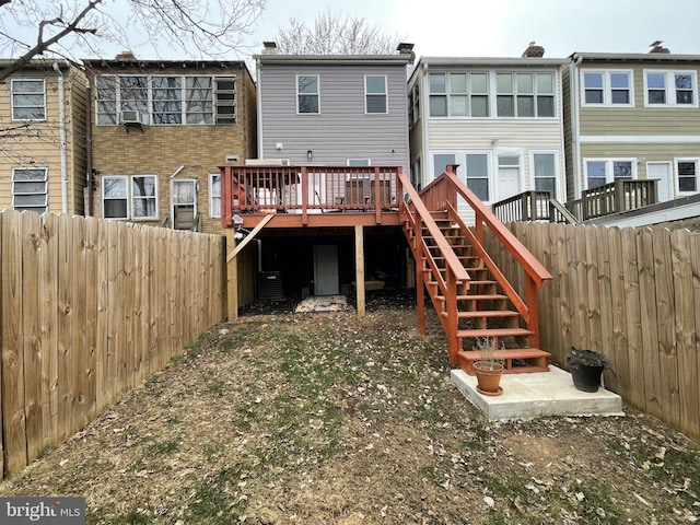 back of property with a fenced backyard, stairs, cooling unit, and a wooden deck