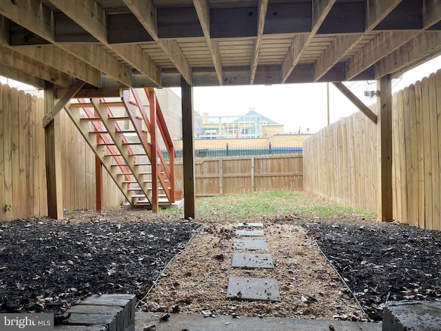 view of yard featuring stairs and fence