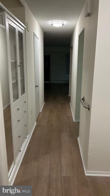 hallway with dark hardwood / wood-style floors