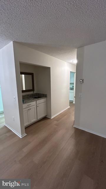 spare room with hardwood / wood-style flooring and a textured ceiling