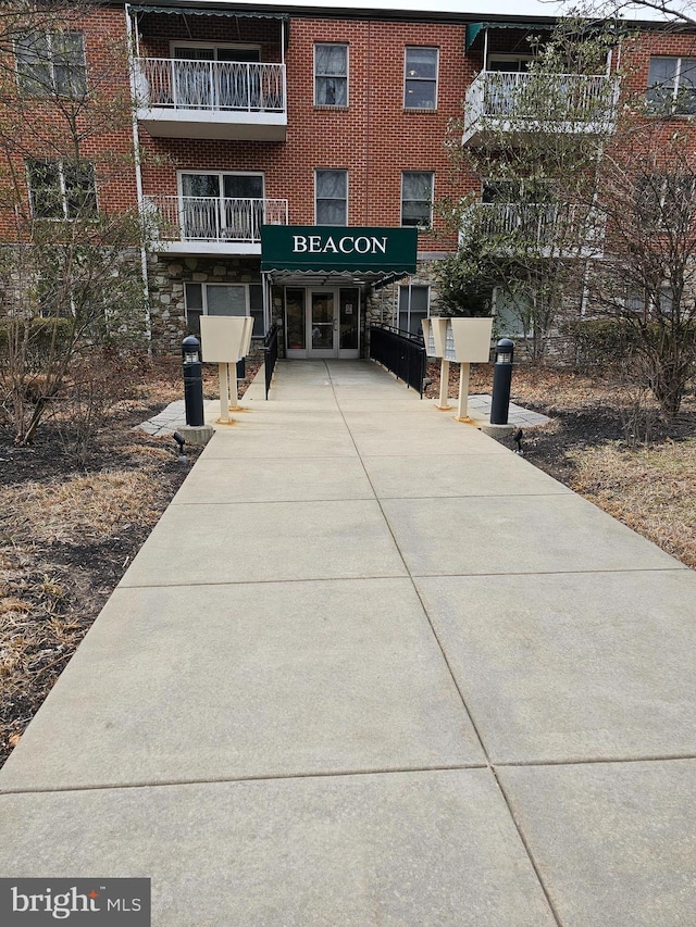 view of building exterior featuring a carport and concrete driveway