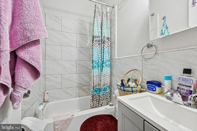 bathroom featuring vanity, shower / tub combo, and tile walls