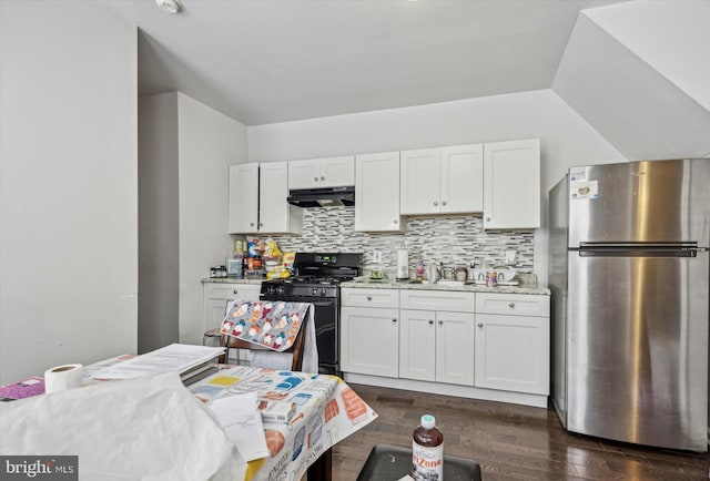 kitchen with white cabinetry, stainless steel fridge, light stone countertops, and black range with gas cooktop