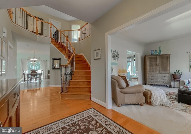 23534 Belmar Dr, Leonardtown, MD 20650 - staircase featuring baseboards, a notable chandelier, and wood finished floors