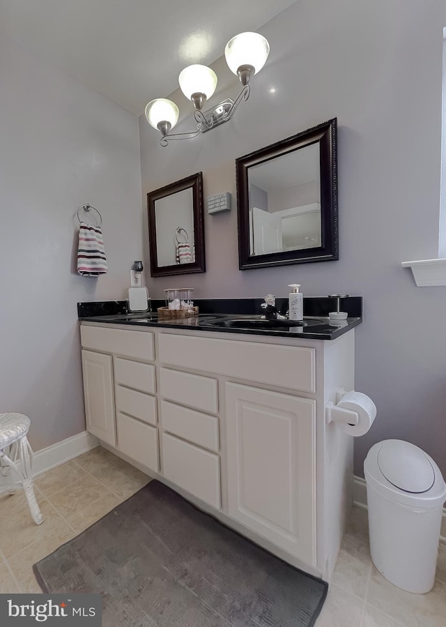 23534 Belmar Dr, Leonardtown, MD 20650 - bathroom featuring double vanity, baseboards, a sink, and tile patterned flooring
