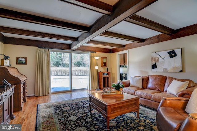 living area featuring light wood finished floors and beam ceiling