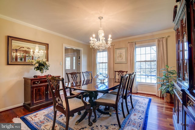 dining area with ornamental molding, a chandelier, baseboards, and wood finished floors