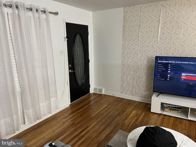 foyer entrance with dark hardwood / wood-style floors