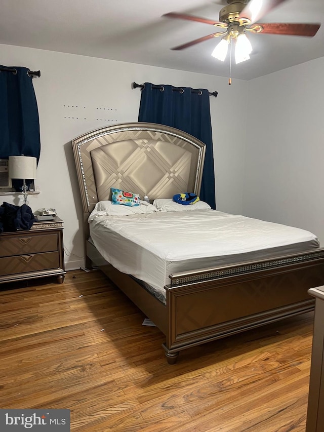 bedroom with hardwood / wood-style floors and ceiling fan