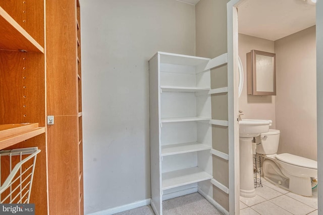 5340 Holmes Run Pkwy Unit 101, Alexandria, VA 22304 - bathroom with toilet, baseboards, and tile patterned flooring