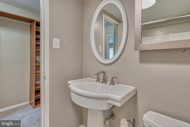 5340 Holmes Run Pkwy Unit 101, Alexandria, VA 22304 - half bathroom featuring toilet, a sink, and baseboards