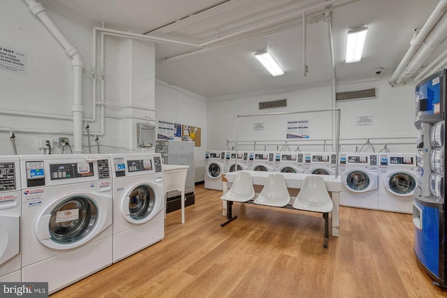 5340 Holmes Run Pkwy Unit 101, Alexandria, VA 22304 - community laundry featuring washer and dryer, wood finished floors, and concrete block wall