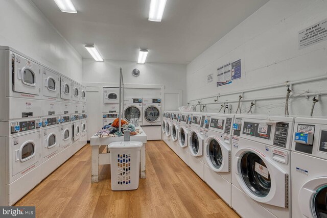 5340 Holmes Run Pkwy Unit 101, Alexandria, VA 22304 - communal laundry room with estacked washer and dryer, washing machine and clothes dryer, and light wood-type flooring