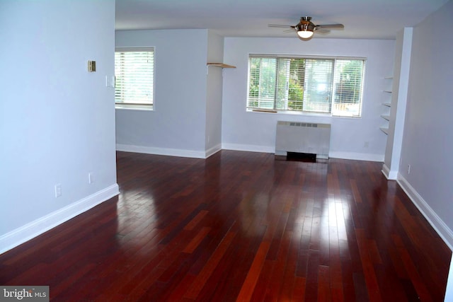 5340 Holmes Run Pkwy Unit 101, Alexandria, VA 22304 - unfurnished living room with radiator, plenty of natural light, a ceiling fan, and dark wood-style floors