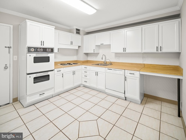 kitchen featuring crown molding, white appliances, white cabinets, and a sink