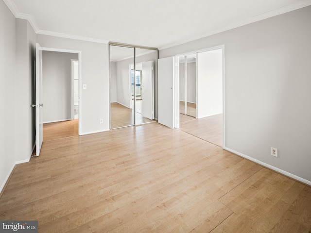 unfurnished bedroom featuring light wood finished floors, baseboards, and ornamental molding