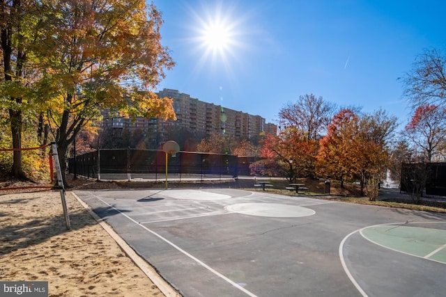 view of basketball court featuring community basketball court and fence