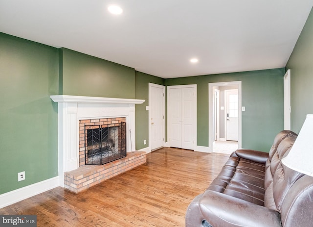 living room featuring hardwood / wood-style flooring and a fireplace