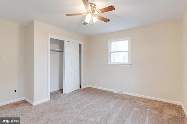 unfurnished bedroom featuring light carpet, ceiling fan, and a closet