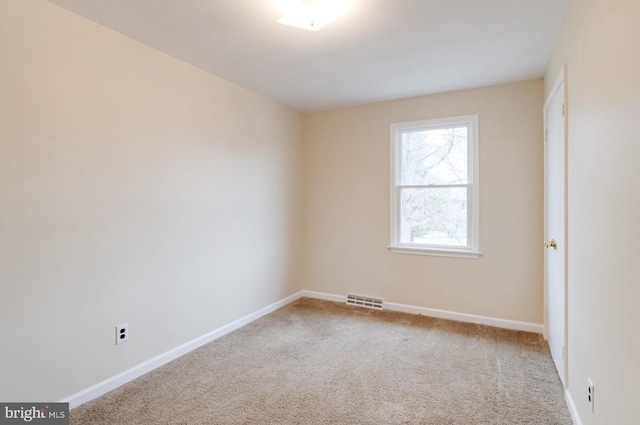 spare room featuring carpet