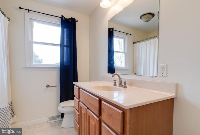 bathroom featuring tile patterned floors, vanity, and toilet