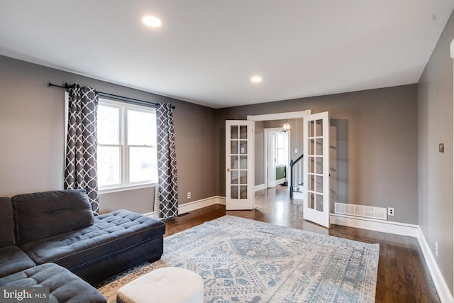 living room featuring french doors and dark hardwood / wood-style flooring