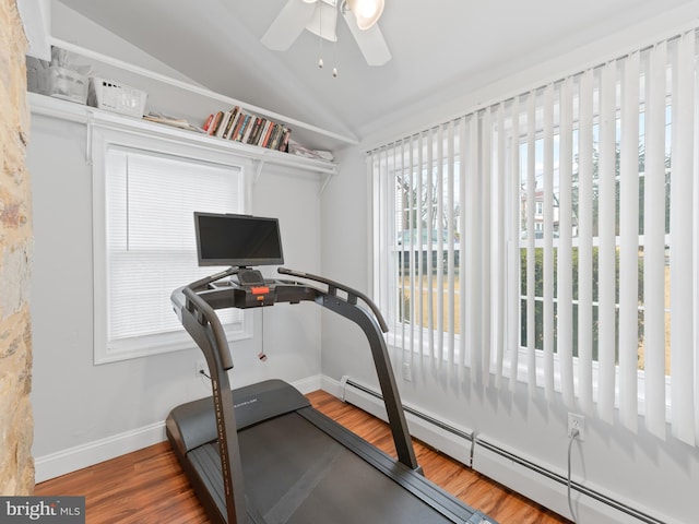 exercise area featuring a baseboard radiator, lofted ceiling, hardwood / wood-style floors, and ceiling fan