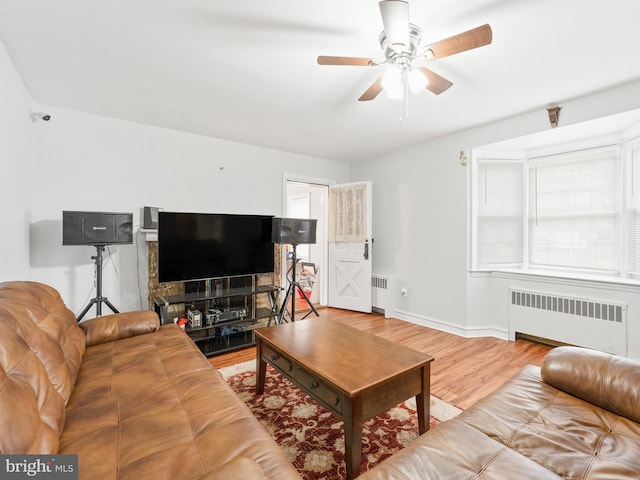 living room featuring ceiling fan, radiator, and hardwood / wood-style floors