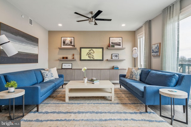 living room with recessed lighting, visible vents, ceiling fan, and wood finished floors