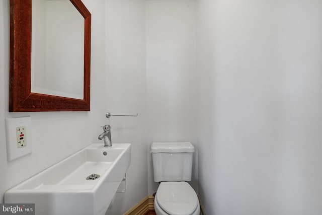 bathroom featuring sink and toilet