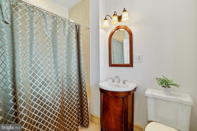 bathroom featuring vanity, toilet, and walk in shower