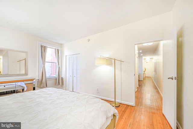 bedroom featuring baseboards and light wood-style floors