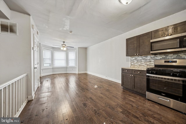 kitchen featuring stainless steel appliances, tasteful backsplash, dark brown cabinets, and dark hardwood / wood-style floors