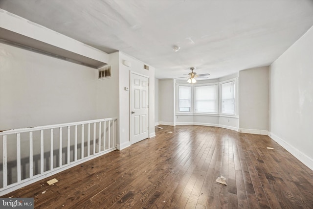 spare room featuring dark hardwood / wood-style floors and ceiling fan